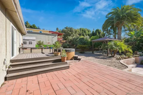 a view of a swimming pool with a patio and a yard