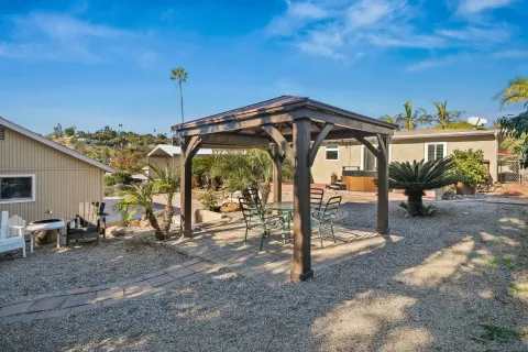 a view of a patio with a table and chairs under an umbrella