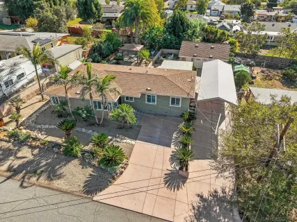 an aerial view of multiple houses with yard