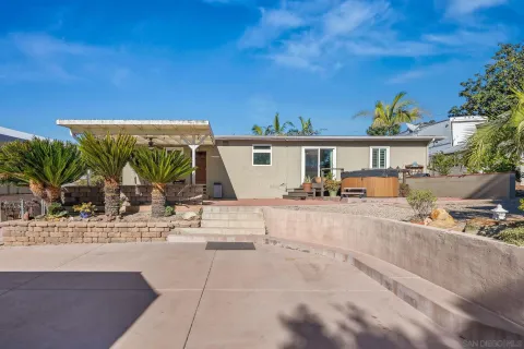 a view of a house with a yard and sitting area