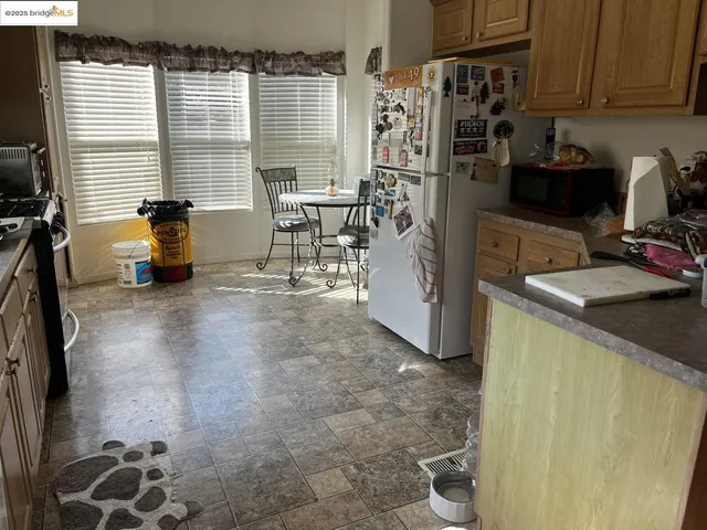 a kitchen with refrigerator and window
