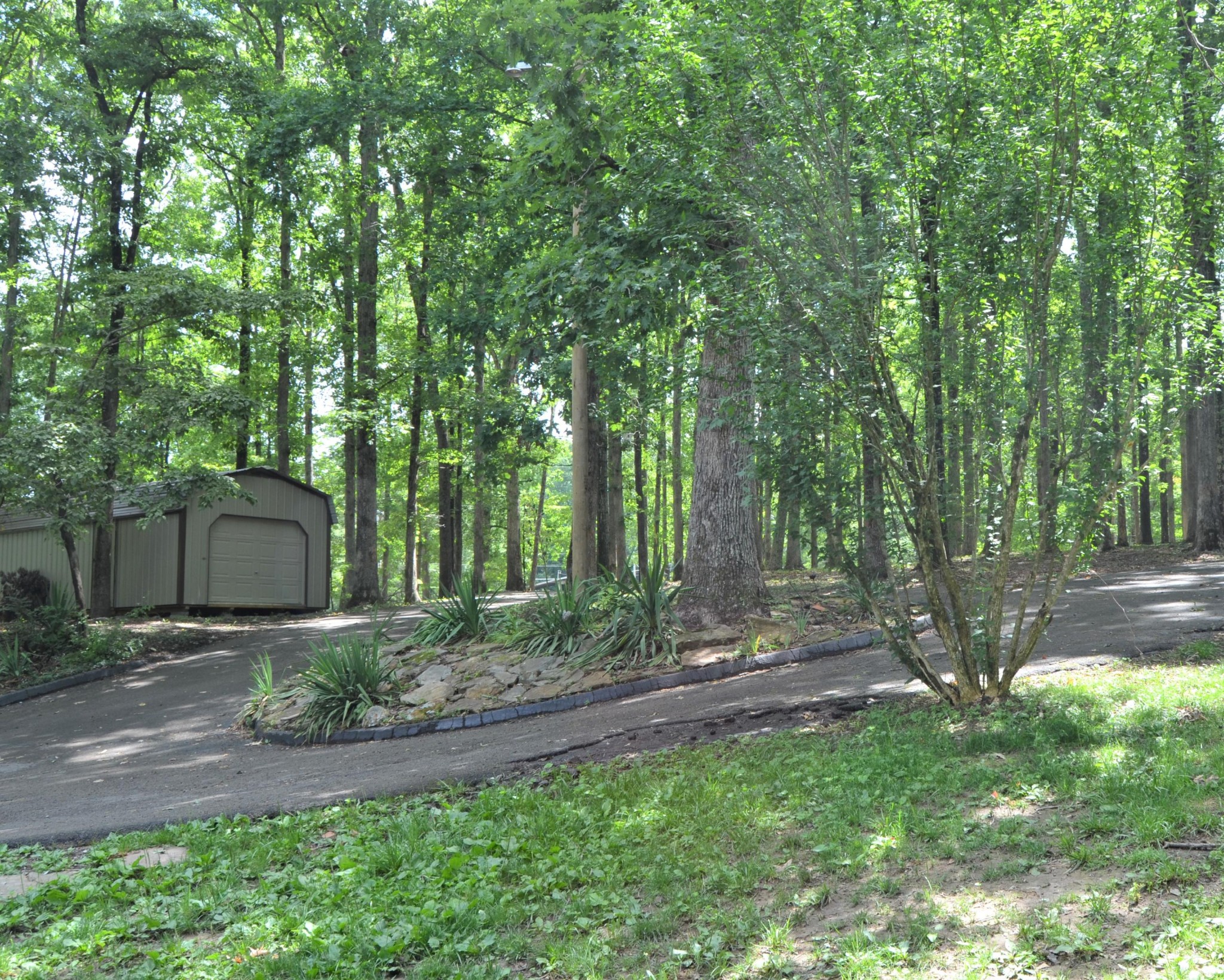 1084 Star Point Road Jamestown, TN 38556 - Photo 33 of 35 a backyard of a house with lots of green space and fountain