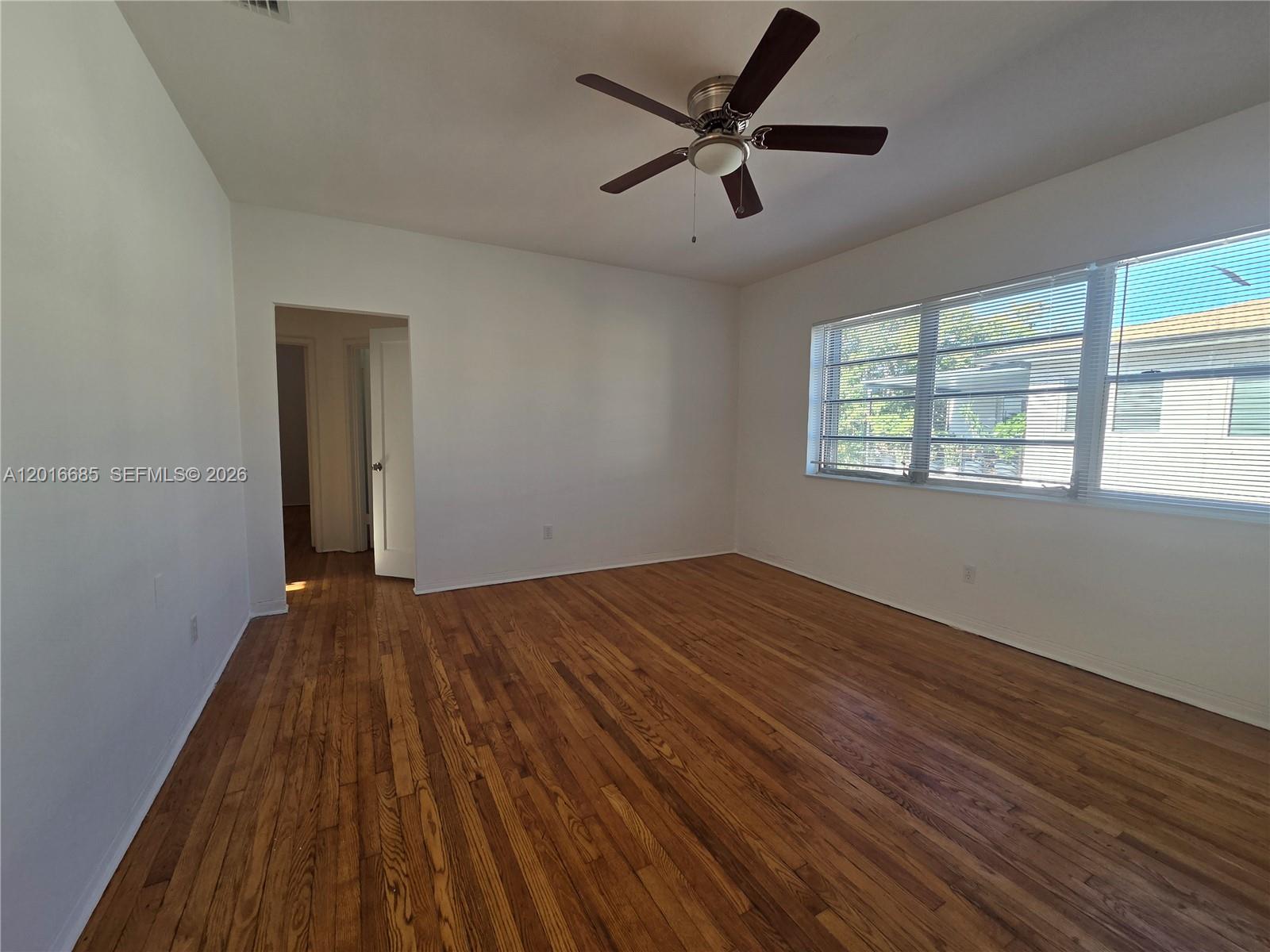 781 Southwest 11th Street, Unit 3 Miami, FL 33129 - Photo 7 of 9 wooden floor in an empty room with a window