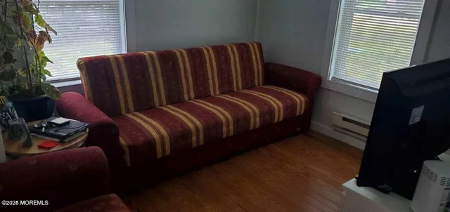 a bedroom with bed and wooden floor