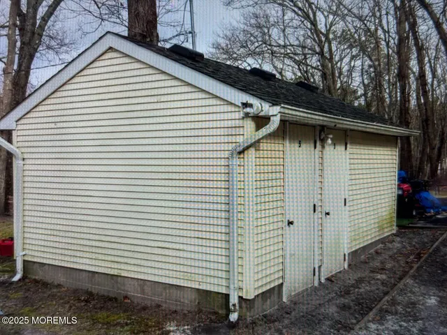 a small white house with a white roof and a yard