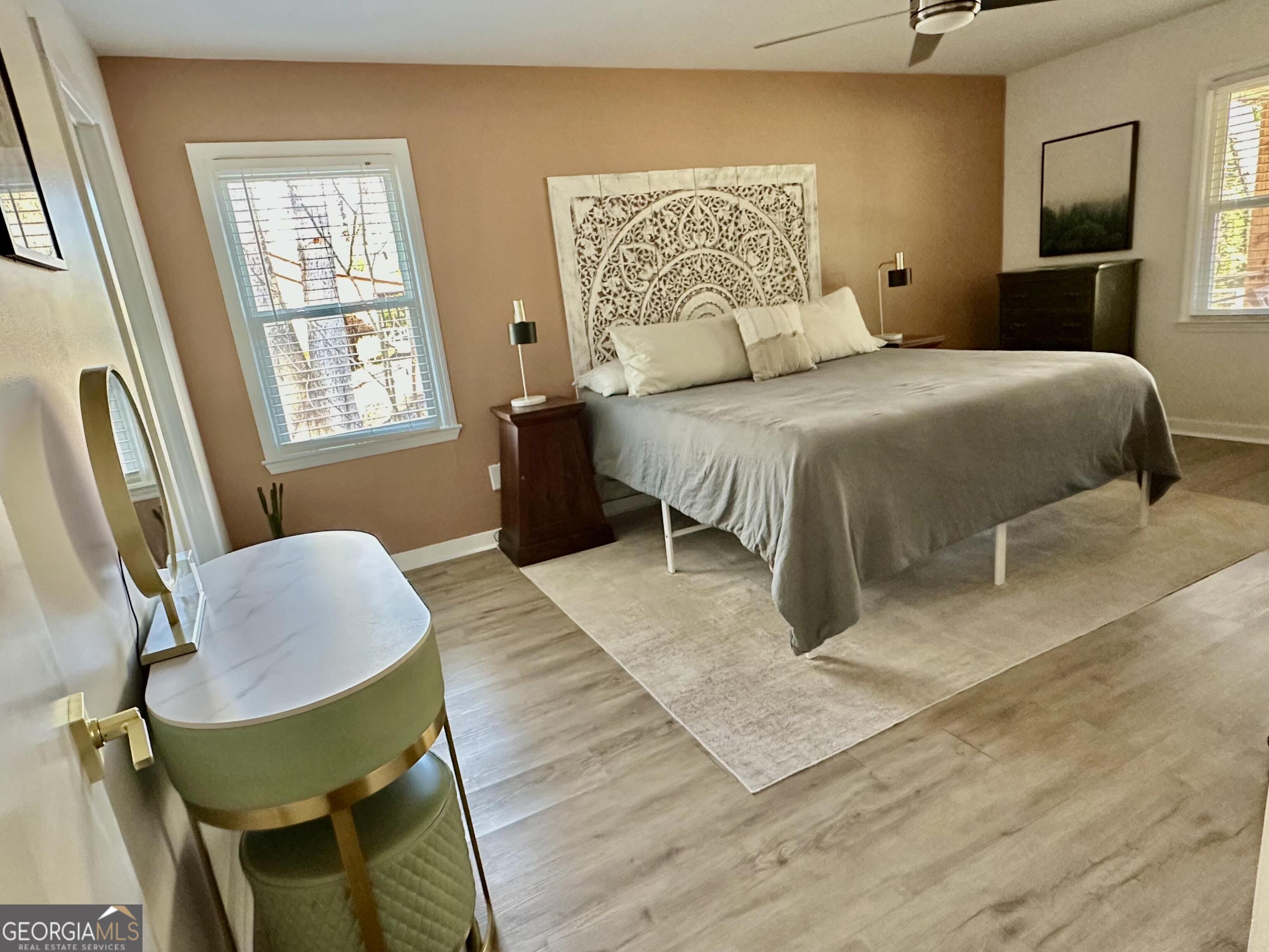 2015 Commonwealth Road Cumming, GA 30041 - Photo 12 of 22 a bedroom with a bed and a chair