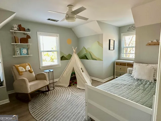 a living room with a bed furniture and a window