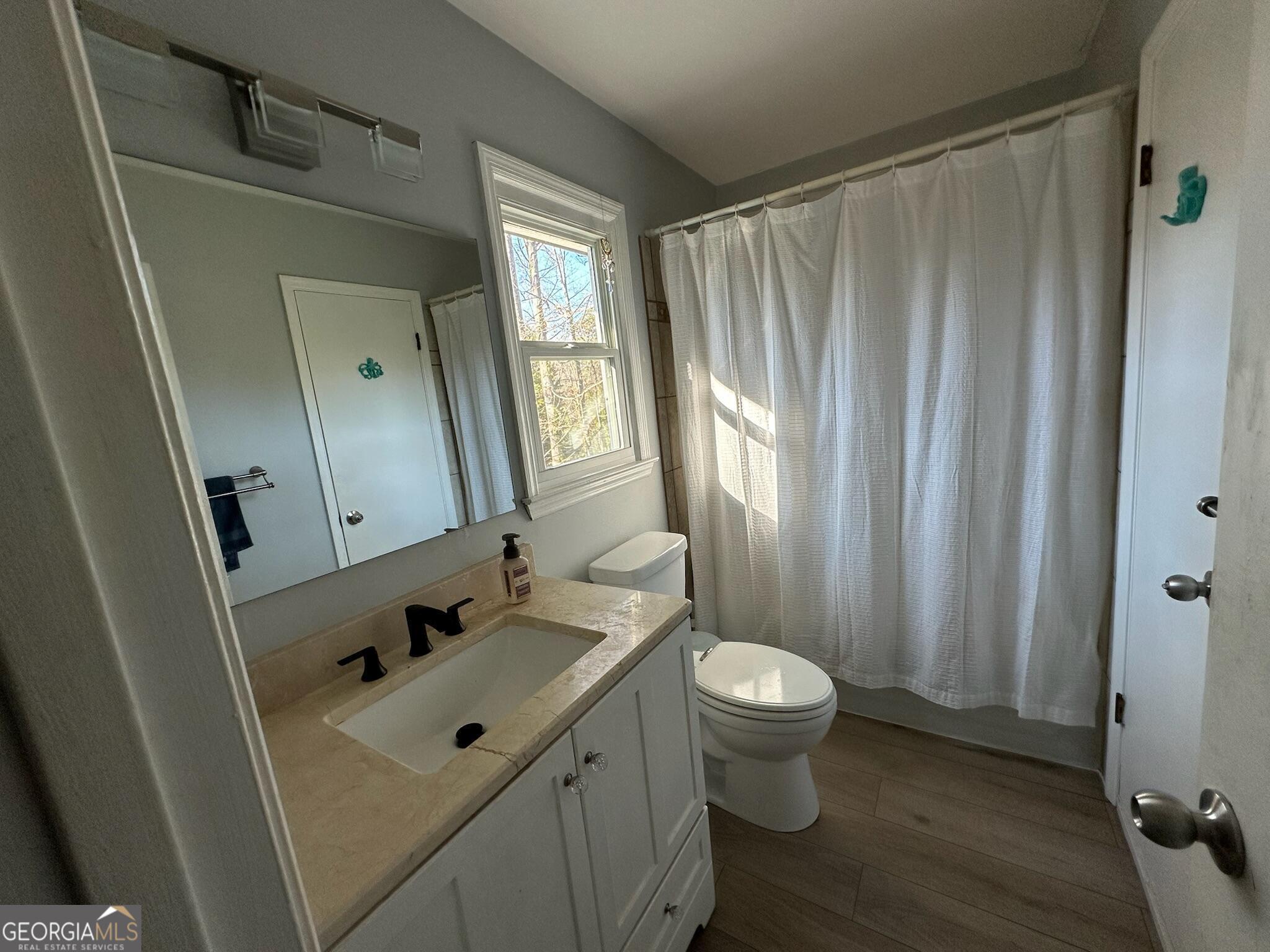 2015 Commonwealth Road Cumming, GA 30041 - Photo 16 of 22 a bathroom with a sink toilet and shower