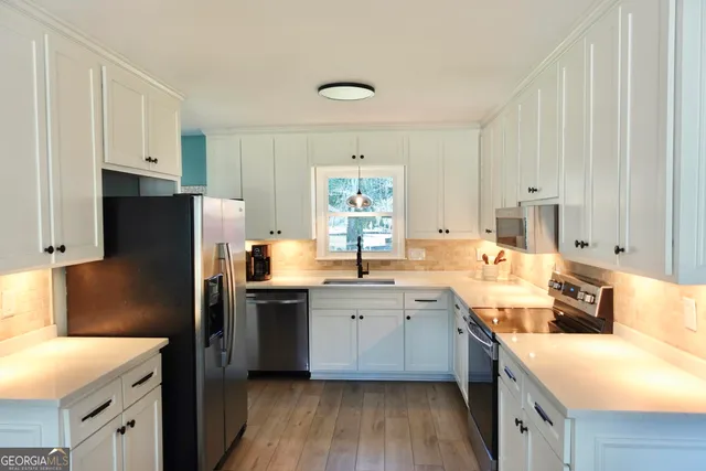 a kitchen with a sink a refrigerator a stove a microwave and island