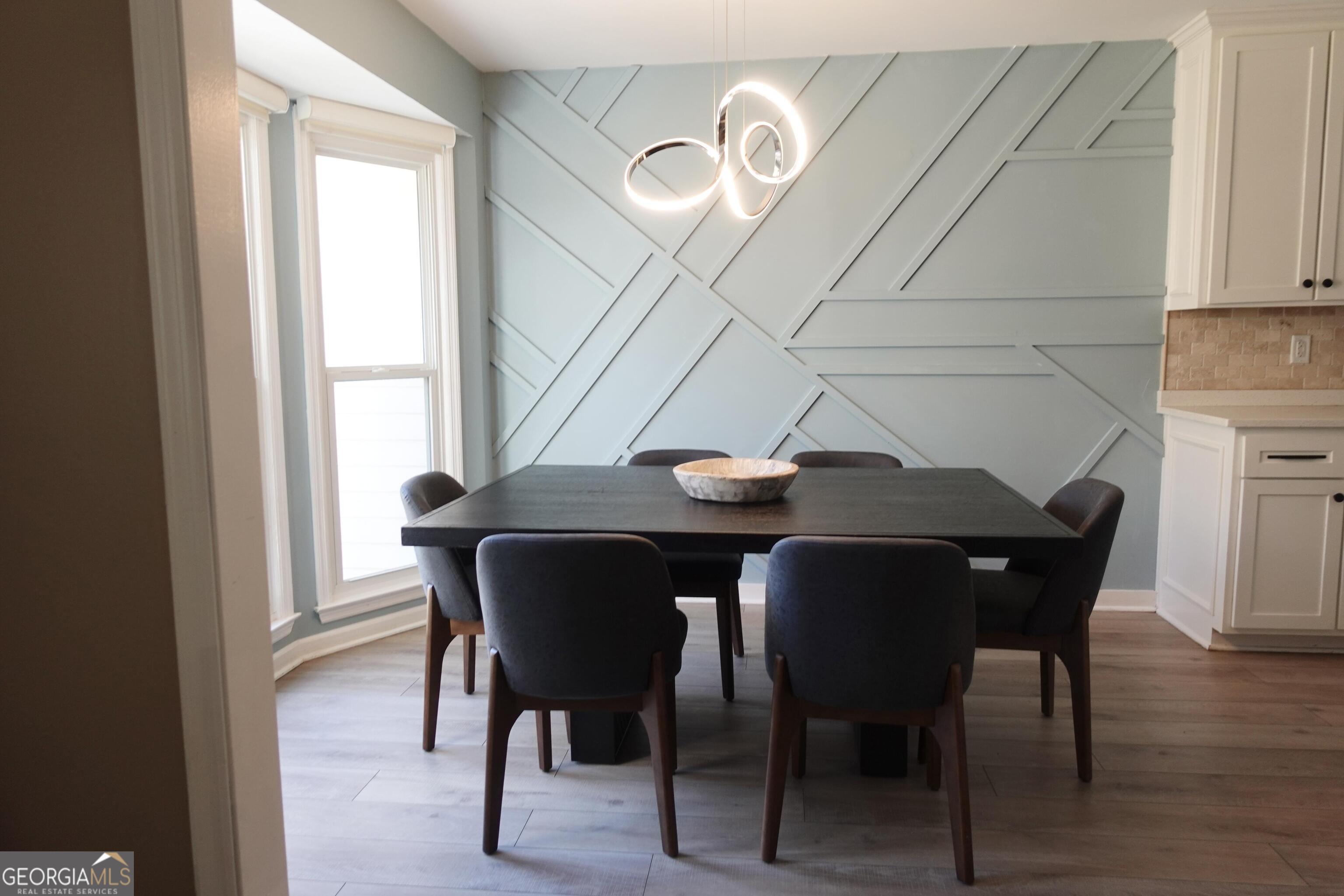 2015 Commonwealth Road Cumming, GA 30041 - Photo 7 of 22 a view of a dining room with furniture and wooden floor