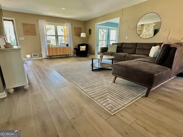 a living room with furniture and a large window