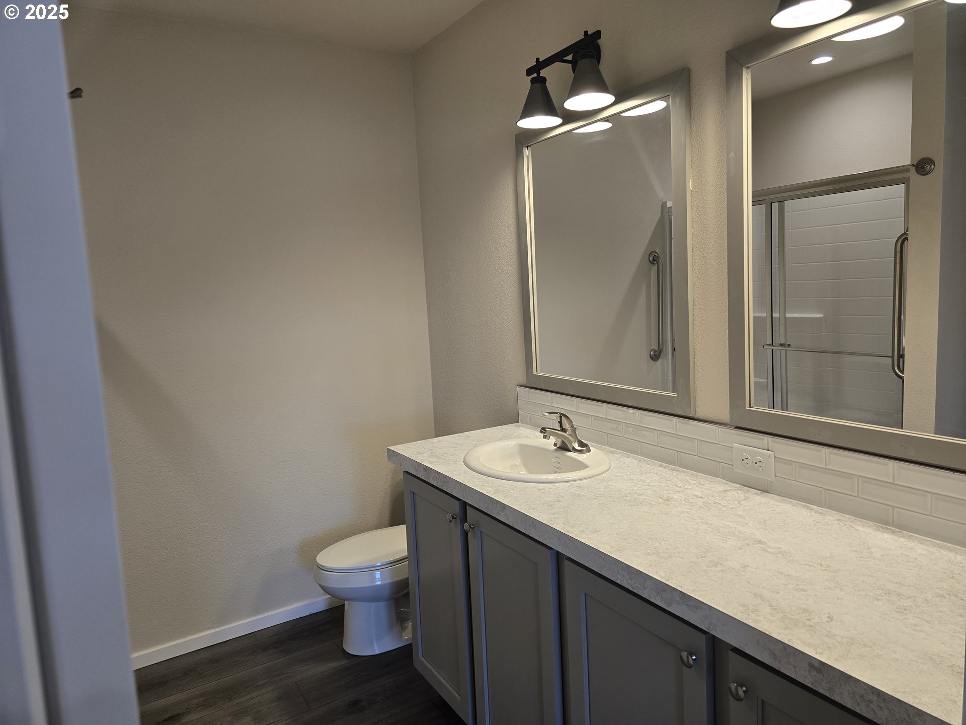 1447 53rd Street Florence, OR 97439 - Photo 15 of 25 a bathroom with a granite countertop sink toilet a large mirror and shower