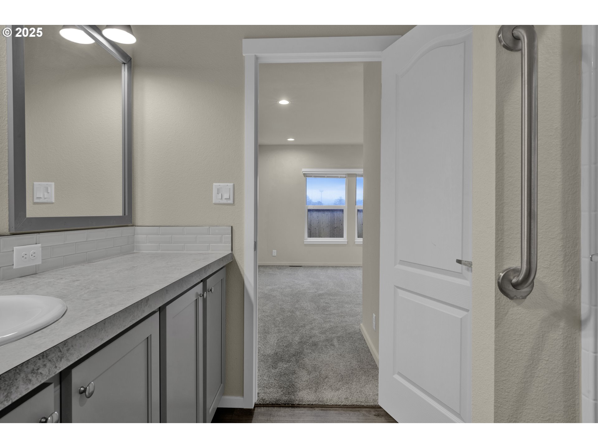 1447 53rd Street Florence, OR 97439 - Photo 18 of 25 a bathroom with a granite countertop sink a mirror and a vanity