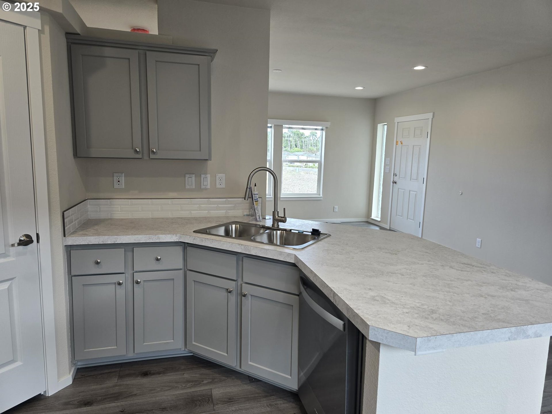 1447 53rd Street Florence, OR 97439 - Photo 8 of 25 a kitchen with a sink cabinets and a window