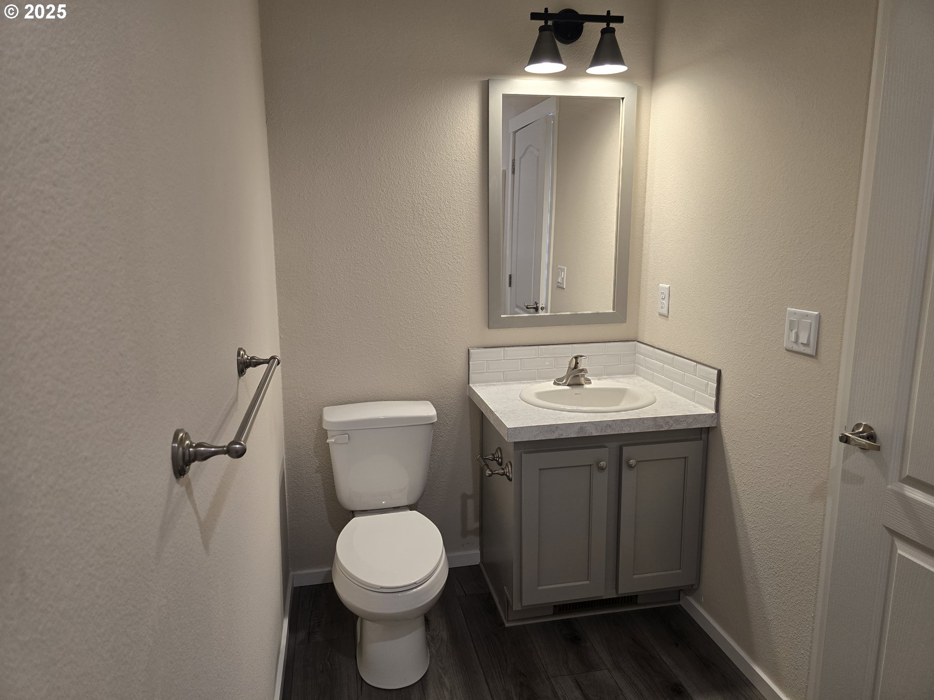 1447 53rd Street Florence, OR 97439 - Photo 10 of 25 a bathroom with a toilet sink and mirror