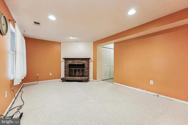 a view of an empty room with a fireplace