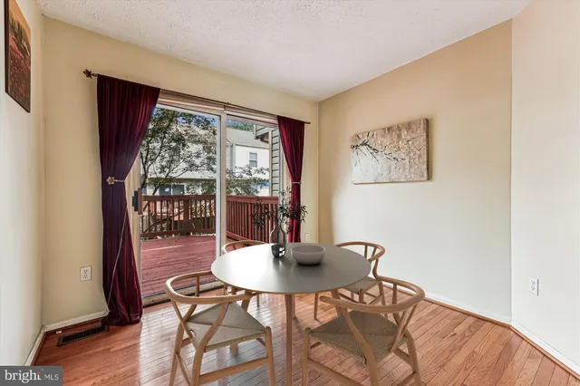 a dining room with furniture and wooden floor