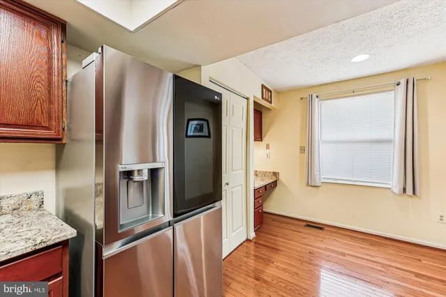 a kitchen with stainless steel appliances granite countertop a refrigerator and a sink
