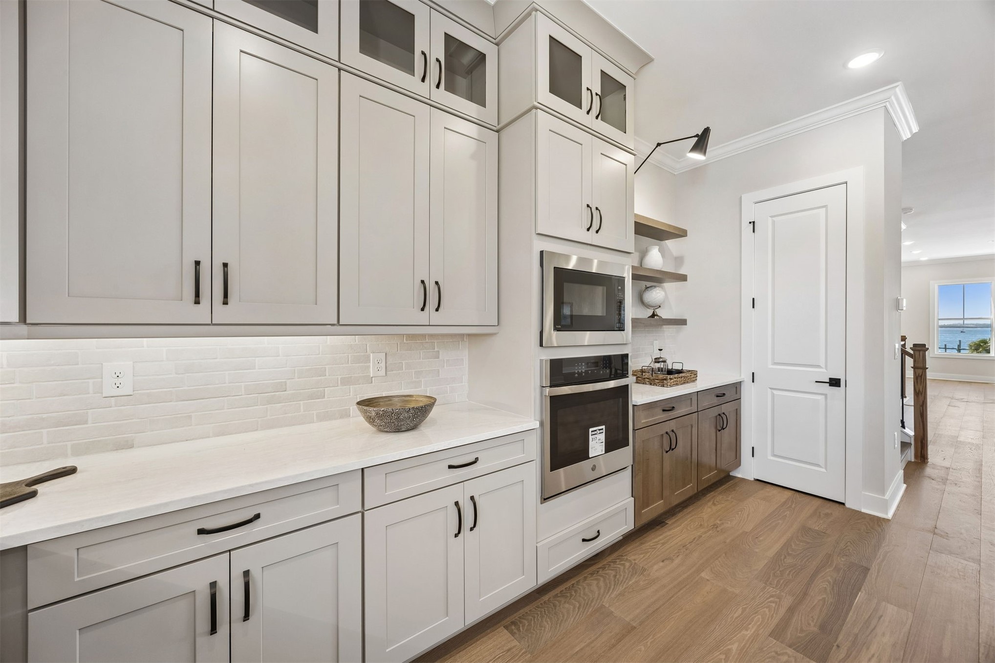 23 North 2nd Street Fernandina Beach, FL 32034 - Photo 20 of 74 a kitchen with stainless steel appliances white cabinets and wooden floors