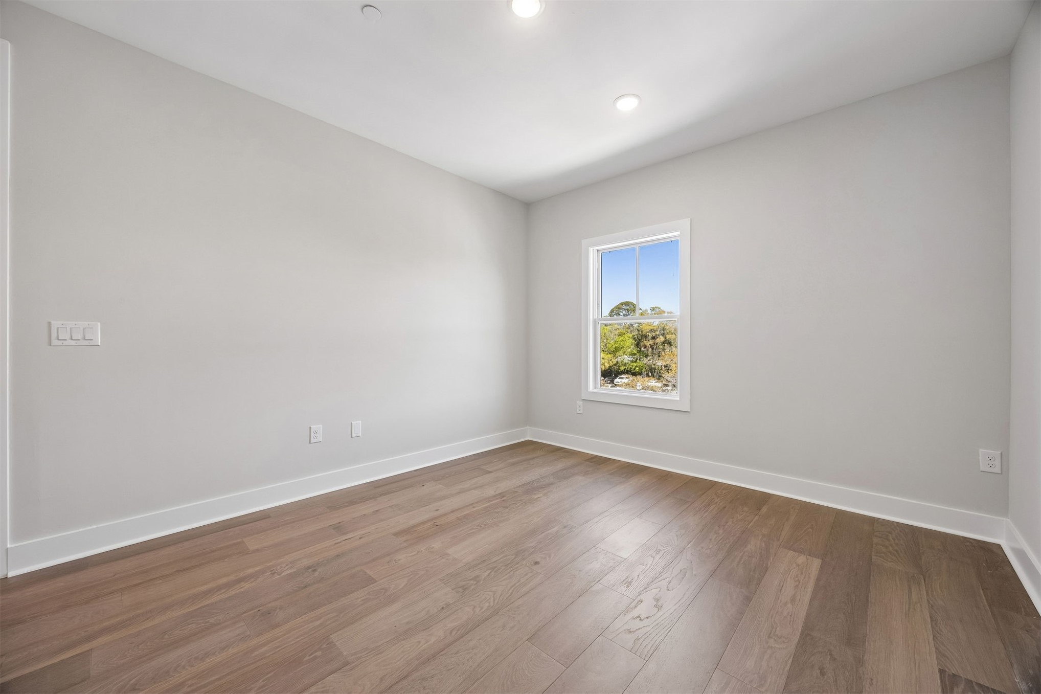 23 North 2nd Street Fernandina Beach, FL 32034 - Photo 45 of 74 an empty room with wooden floor and windows