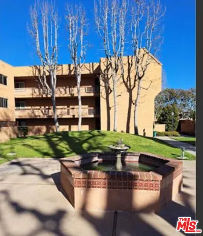 a view of a building with a yard