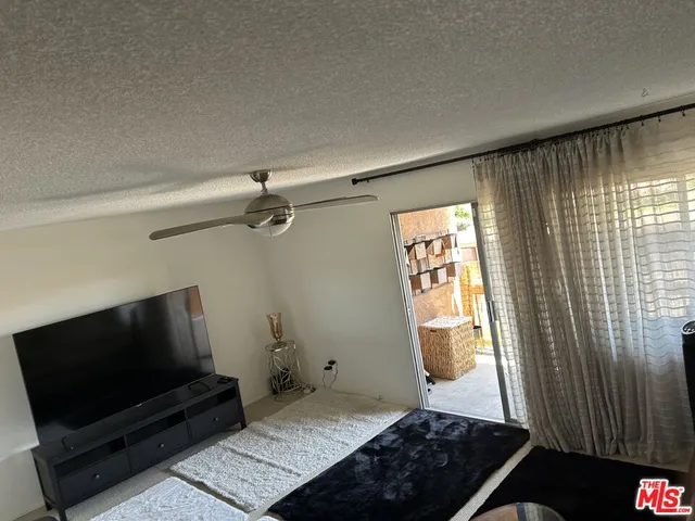 a bedroom with a bed and flat screen tv