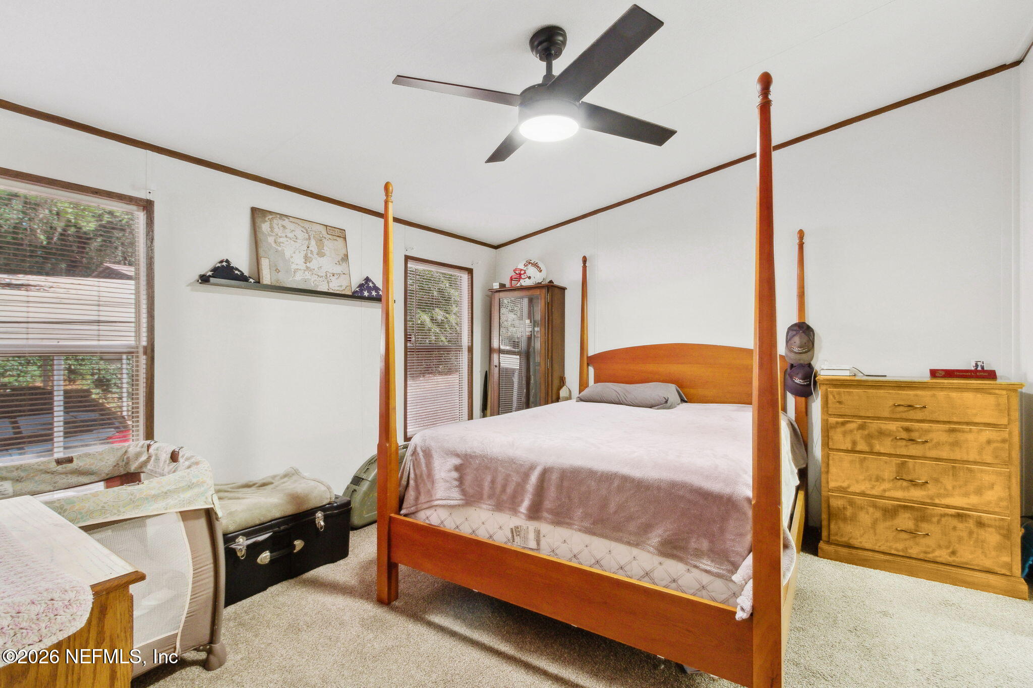 6830 Deer Springs Road Keystone Heights, FL 32656 - Photo 17 of 34 a bedroom with a bed and a table
