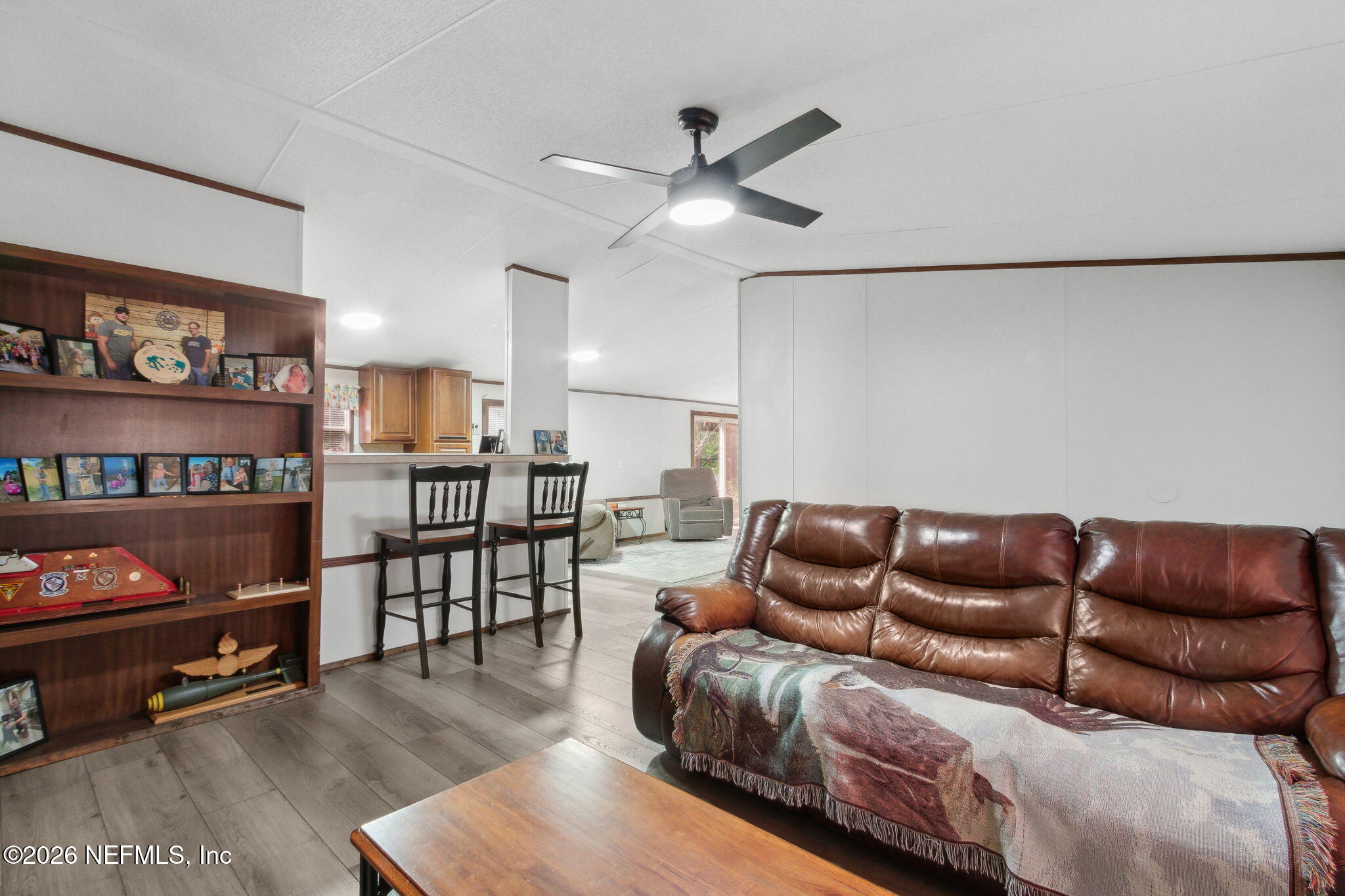 6830 Deer Springs Road Keystone Heights, FL 32656 - Photo 8 of 34 a living room with furniture and a book shelf