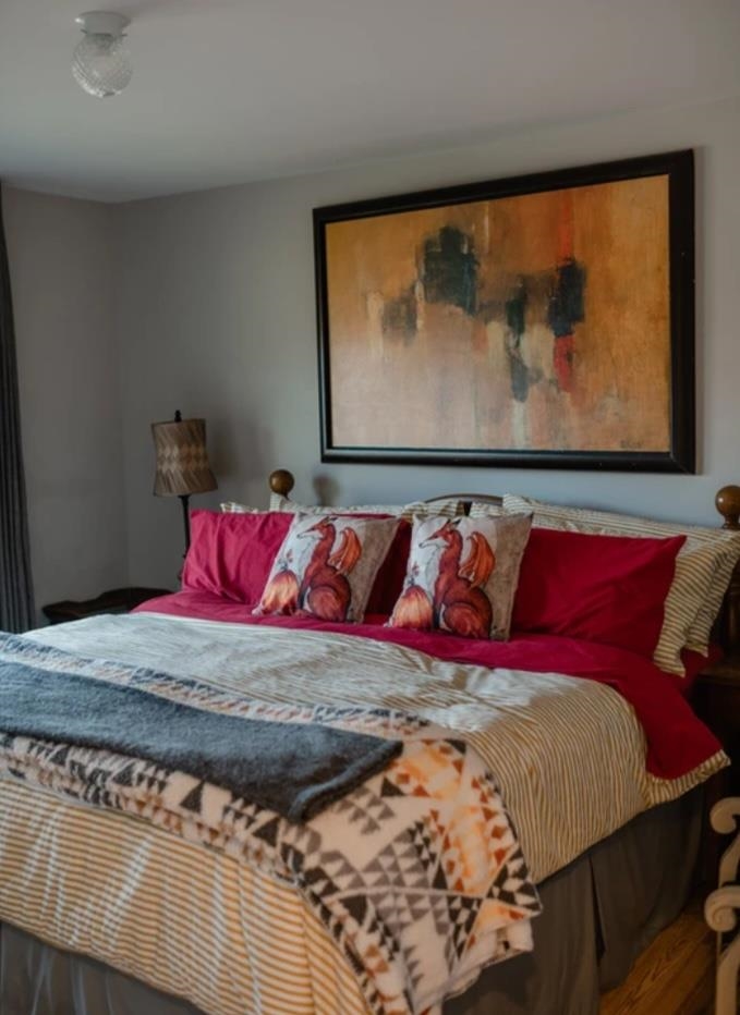 1103 Quick's Mill Road Staunton, VA 24401 - Photo 48 of 53 a bed sitting in a bedroom next to a painting on the wall
