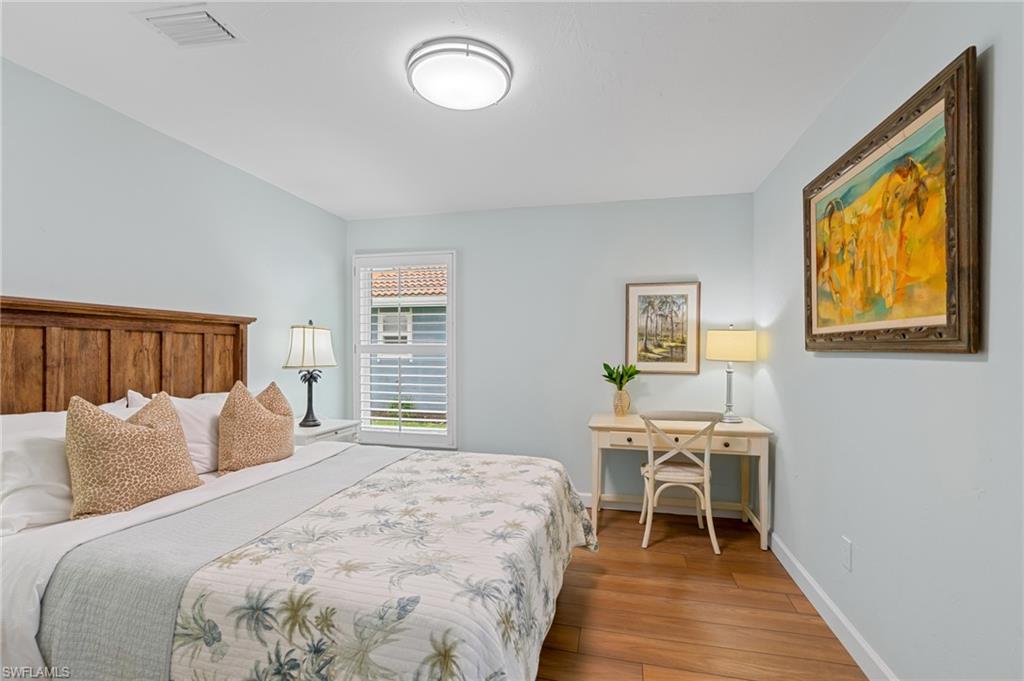2218 Kings Lake Boulevard Naples, FL 34112 - Photo 19 of 50 a bedroom with a bed and a window