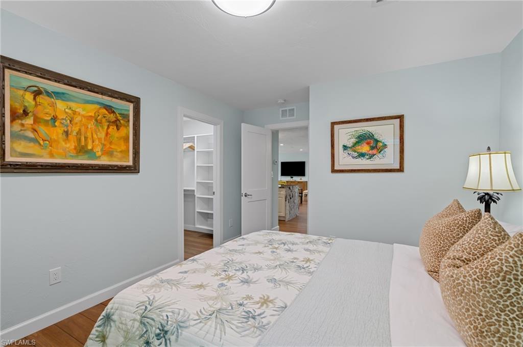 2218 Kings Lake Boulevard Naples, FL 34112 - Photo 20 of 50 a bedroom with bed and painting on the wall