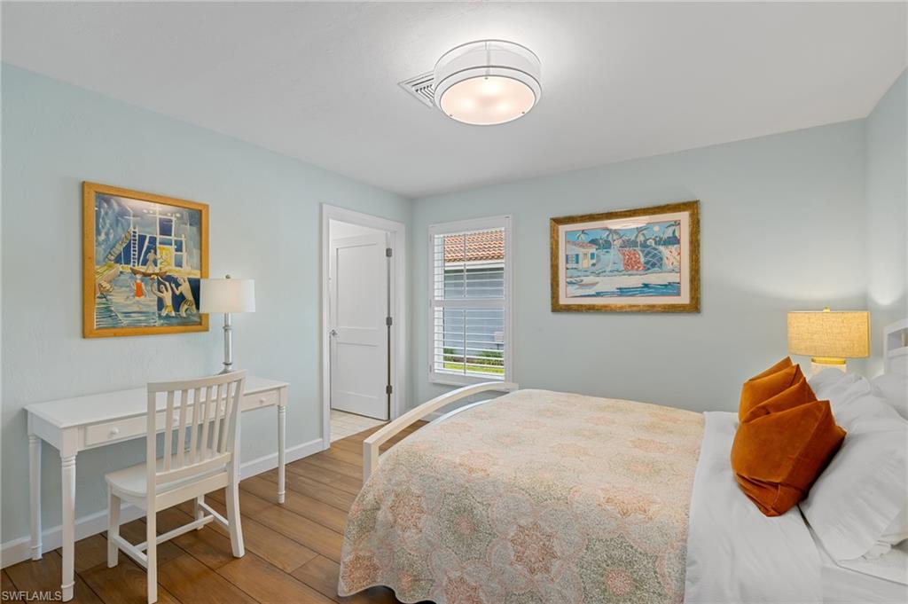 2218 Kings Lake Boulevard Naples, FL 34112 - Photo 24 of 50 a bedroom with a bed and painting on the wall