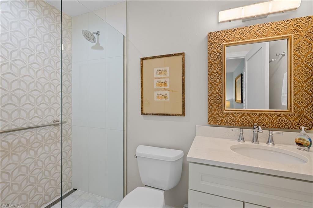 2218 Kings Lake Boulevard Naples, FL 34112 - Photo 26 of 50 a bathroom with a toilet sink and mirror