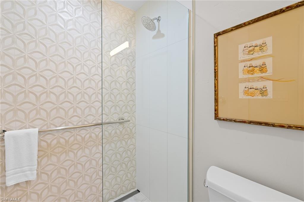 2218 Kings Lake Boulevard Naples, FL 34112 - Photo 27 of 50 a bathroom with a shower curtain