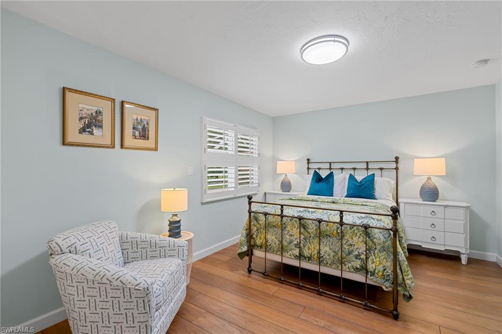 2218 Kings Lake Boulevard Naples, FL 34112 - Photo 29 of 50 a bedroom with furniture and a couch