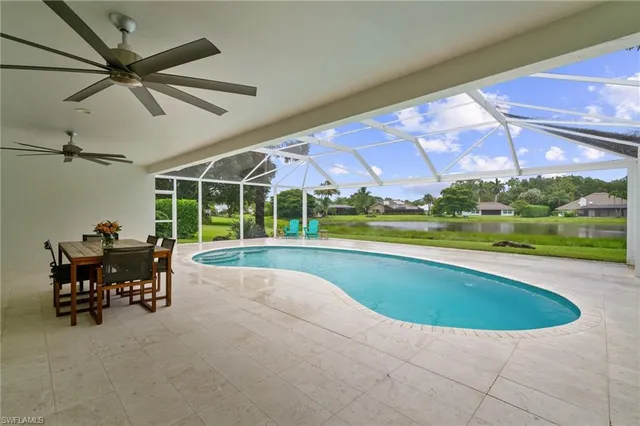 a view of swimming pool with outdoor seating and yard