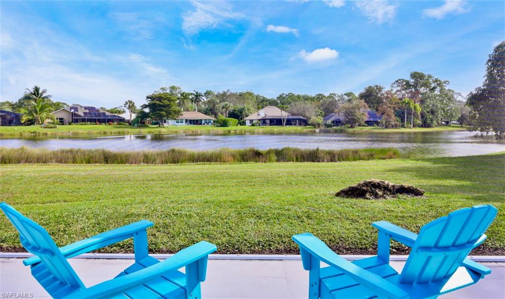 2218 Kings Lake Boulevard Naples, FL 34112 - Photo 32 of 50 a view of a lake with a yard and outdoor seating