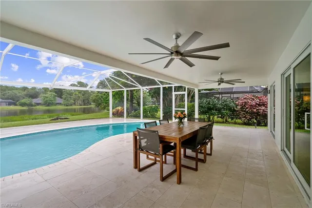 a view of a patio with a table chairs and a swimming pool