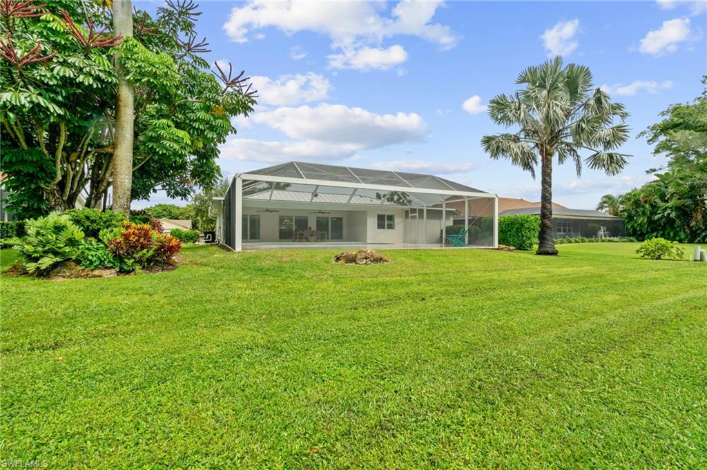 2218 Kings Lake Boulevard Naples, FL 34112 - Photo 36 of 50 a front view of house with yard and green space