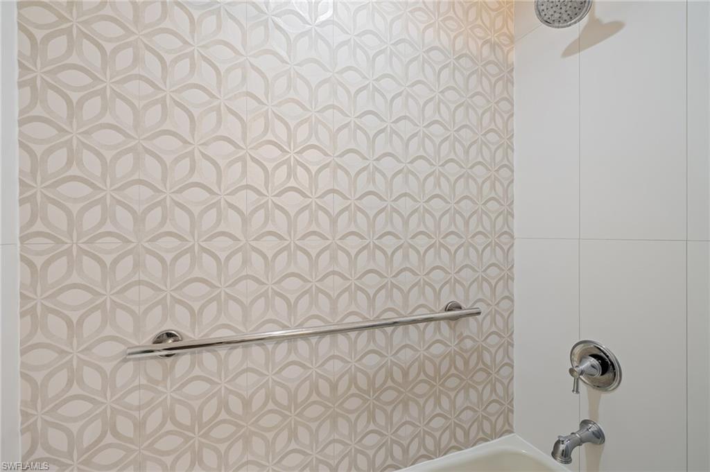 2218 Kings Lake Boulevard Naples, FL 34112 - Photo 38 of 50 a bathroom with a white shower curtain