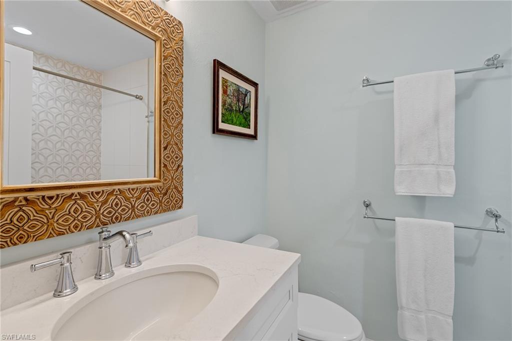 2218 Kings Lake Boulevard Naples, FL 34112 - Photo 40 of 50 a bathroom with a sink toilet and mirror