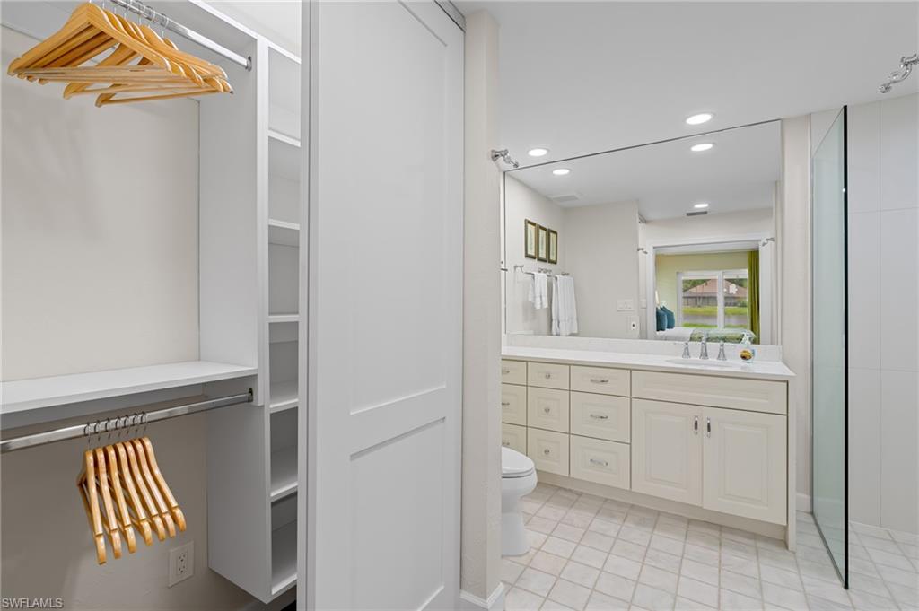 2218 Kings Lake Boulevard Naples, FL 34112 - Photo 42 of 50 a spacious bathroom with a sink and a mirror