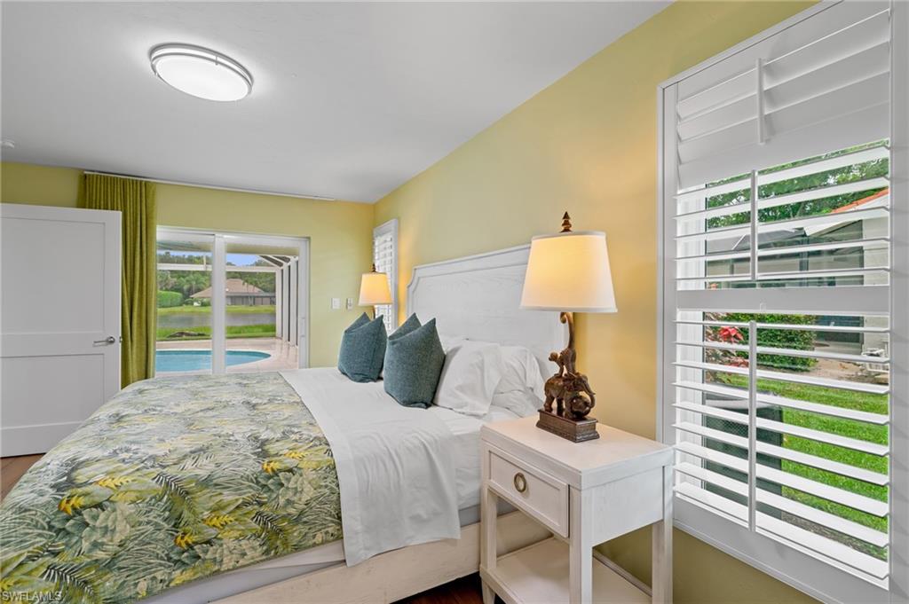 2218 Kings Lake Boulevard Naples, FL 34112 - Photo 45 of 50 a bedroom with a bed and a window
