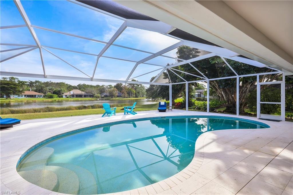 2218 Kings Lake Boulevard Naples, FL 34112 - Photo 49 of 50 a view of a swimming pool with a yard