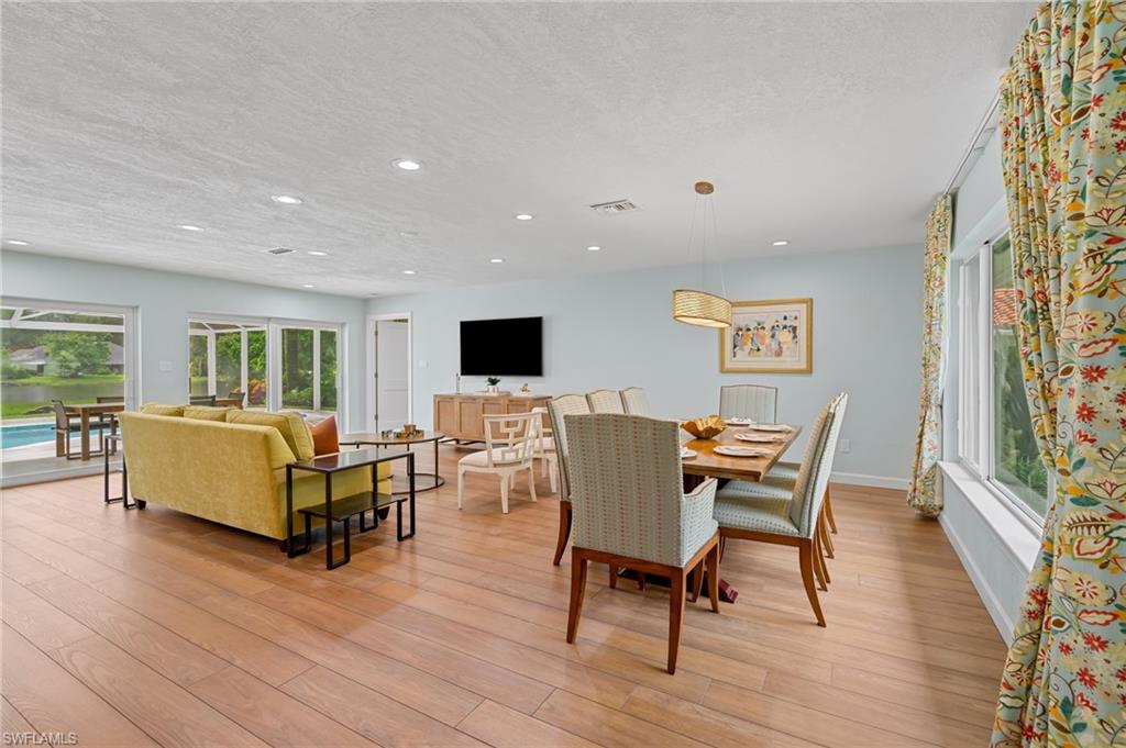 2218 Kings Lake Boulevard Naples, FL 34112 - Photo 9 of 50 a living room with furniture and a wooden floor