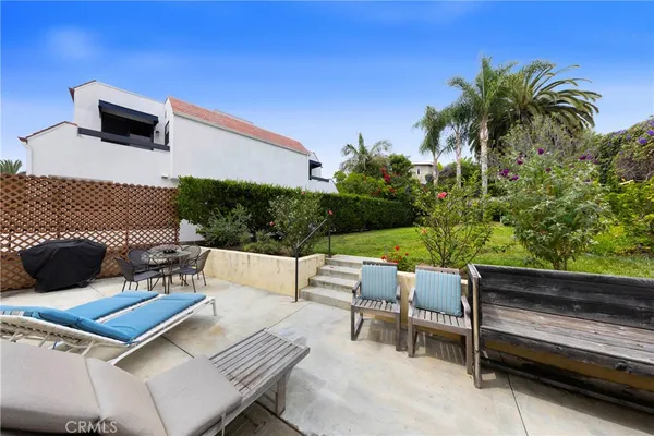 a view of backyard of house with green space