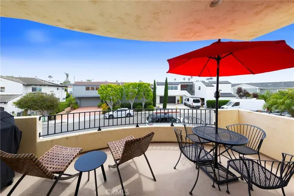 a view of a patio with a table and chairs under an umbrella