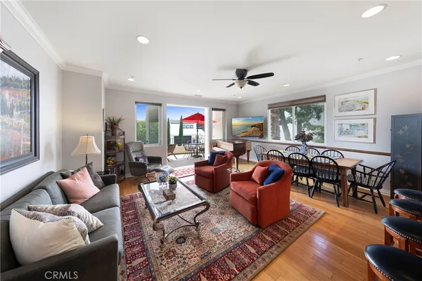a living room with furniture kitchen view and a window