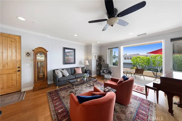 a living room with furniture ceiling fan and a rug