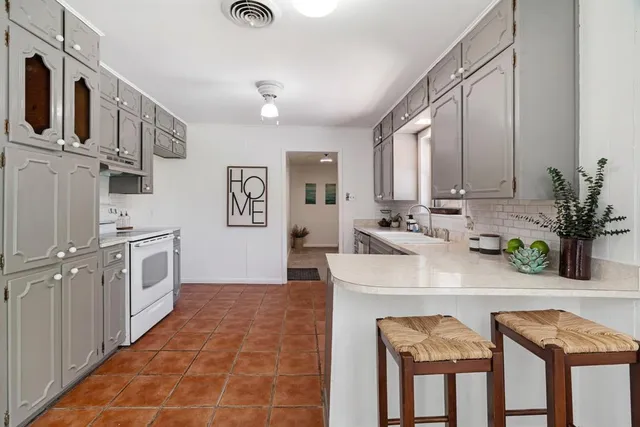 a kitchen with stainless steel appliances granite countertop a sink and cabinets